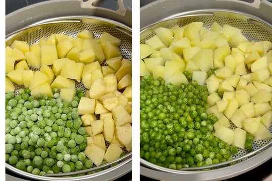 "Steamed green peas and diced potatoes in a steamer basket, ready for cooking, showing a healthy vegetable preparation."