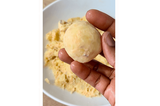 Shaping salmon fish cake mixture into small balls, about 2 tablespoons each, ready for baking or cooking.