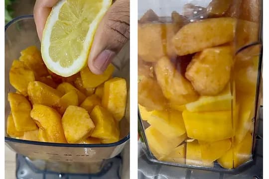 "Adding lemon juice to a blender filled with fresh and frozen mango chunks for a refreshing homemade mango popsicle or smoothie recipe."