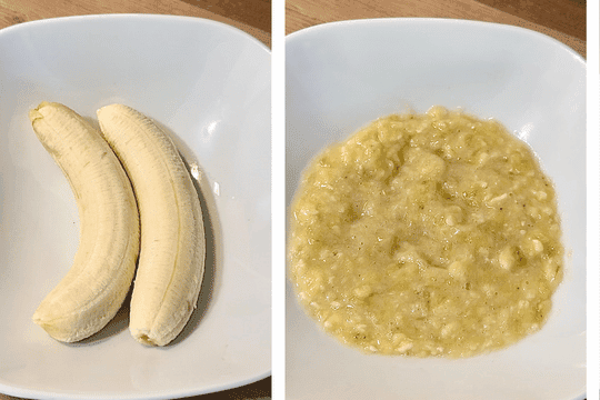 A mixing bowl with peeled ripe bananas being mashed with a fork, leaving a slightly chunky texture for added flavor and softness.