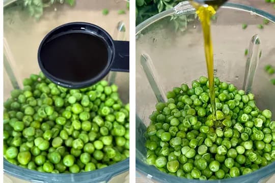 Step-by-step pea puree recipe: Bright green peas in a blender jar, with a measuring spoon adding water on the left, and olive oil being poured over the peas on the right, demonstrating the process for baby food.