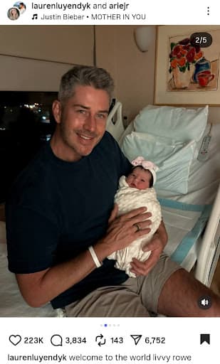 Arie Luyendyk Jr. smiling with the newborn