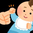 "An 11-month-old baby pulling up to stand using a low table, showing growing strength and balance during this stage of development."