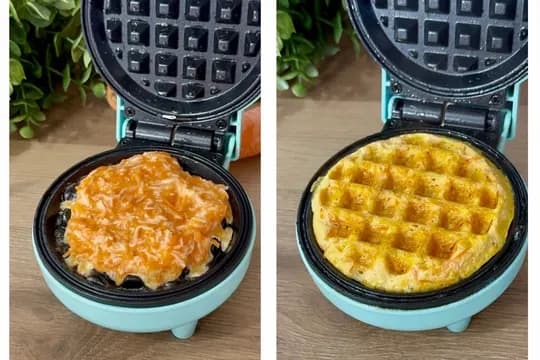 Golden cheesy carrot waffles cooking in a waffle maker until crisp, perfect for a healthy toddler meal or snack