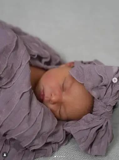 New mom Jessica Sanchez gently holds her first baby in her arms, celebrating motherhood shortly after her America’s Got Talent victory.