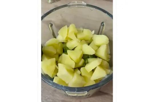 Steaming apple chunks and broccoli florets until soft for baby purée.