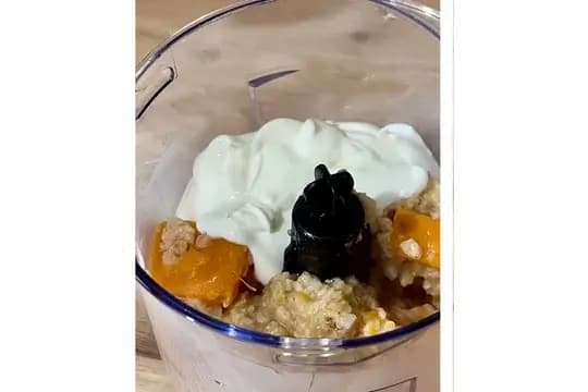Blending cooled sweet potato and oats with plain yogurt to make smooth baby porridge.