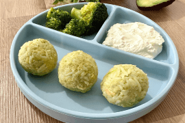Plate of rice balls made with mashed avocado and salmon – a nutritious and flavorful dish rich in healthy fats and protein.