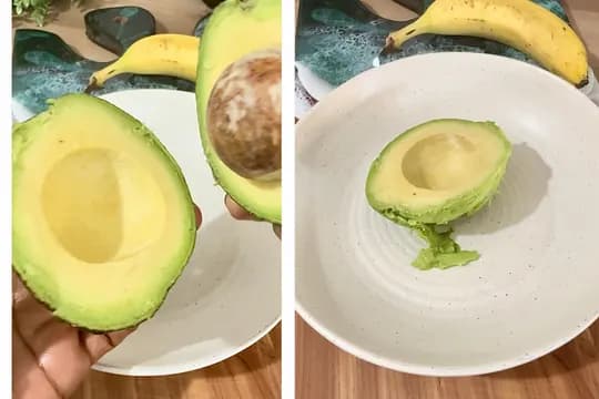 "Fresh avocado halves prepared on a plate next to ripe bananas on a kitchen counter"