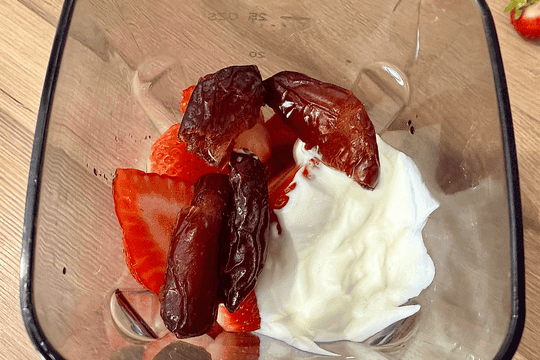 "Strawberries, yogurt, vanilla, and dates added to a blender for homemade popsicles."