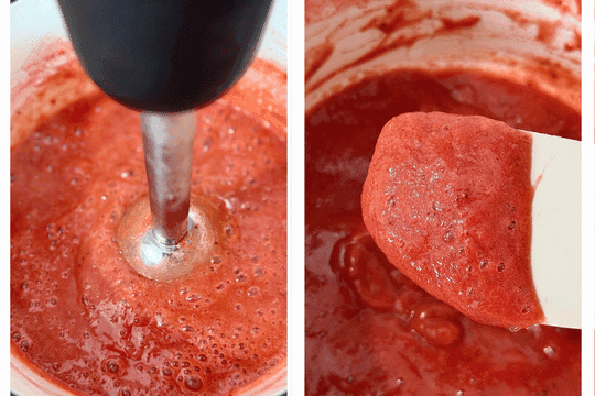 A hand holding an immersion blender blending the cooked fruit mixture in the saucepan until smooth. Alternatively, the mixture is shown in a blender with visible fruit chunks for a textured jam option.