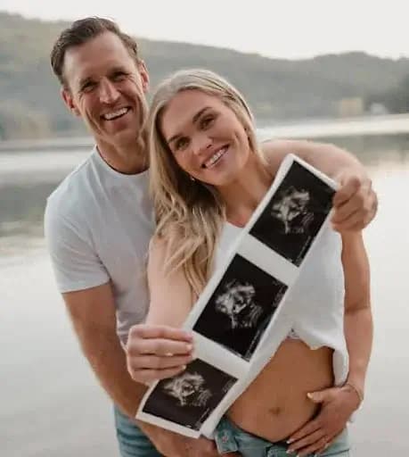 Screenshot of a joyful Instagram post from @katrintanja and @brookslaich, showing the couple beaming with love as they share the happy news of their baby girl’s arrival.