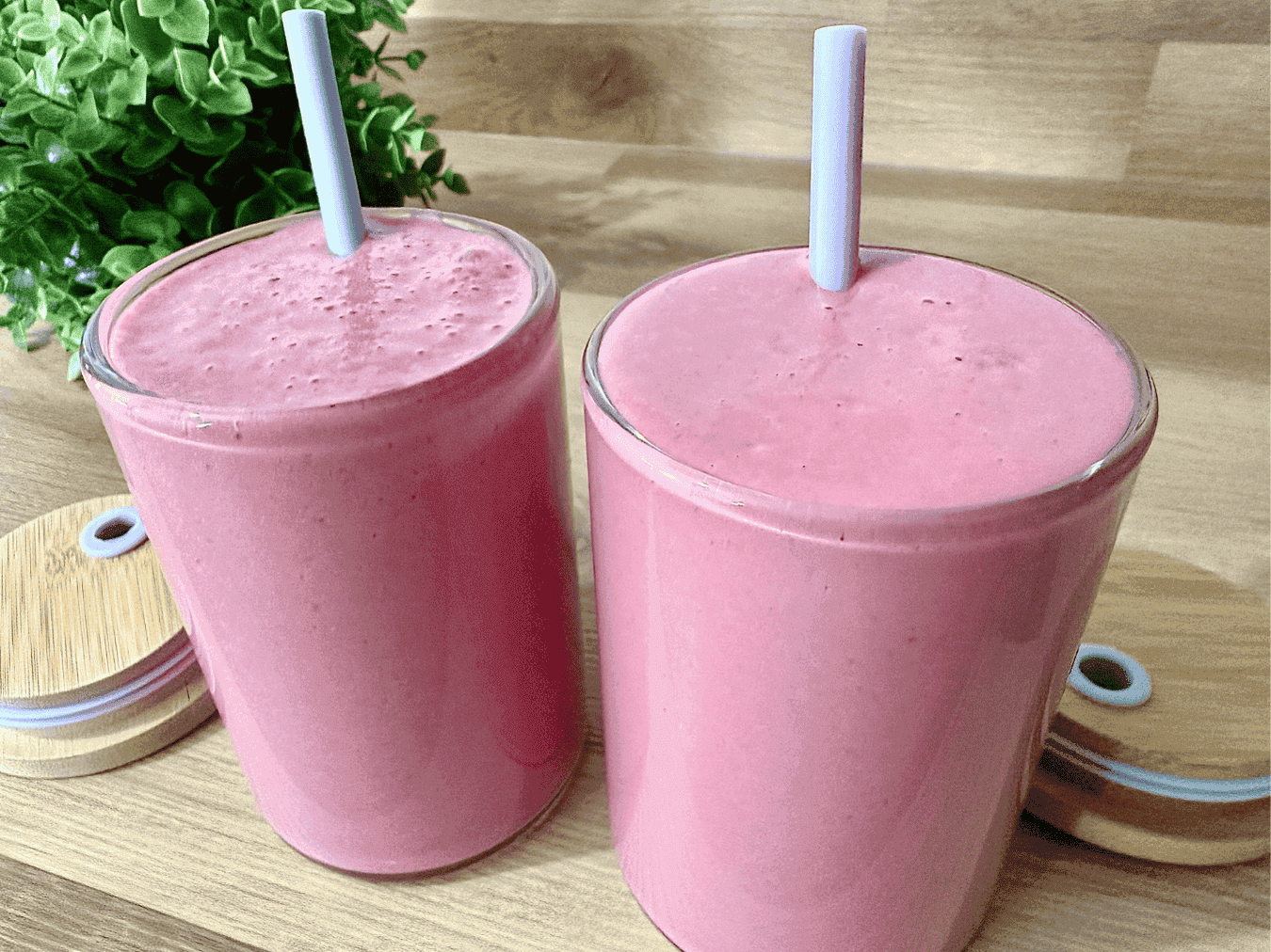 A vibrant pink beet strawberry banana smoothie served in a glass, garnished with fresh strawberry slices. This antioxidant-rich and naturally sweet smoothie is packed with beets, strawberries, and bananas, making it a healthy and delicious drink.