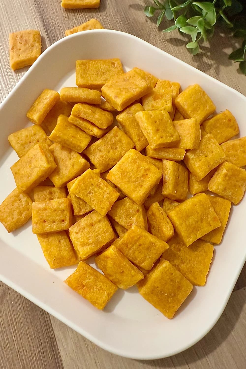 "Homemade sweet potato crackers on a white plate, healthy gluten-free snack idea"