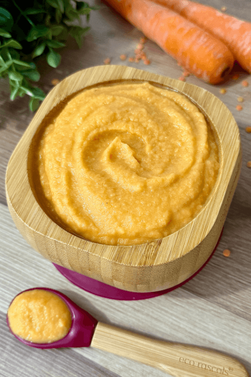 A bowl of smooth and creamy carrot lentil puree, showcasing its rich orange color and velvety texture. This protein-packed and nutrient-dense puree is perfect for babies and toddlers, made with wholesome carrots and lentils for a healthy meal.