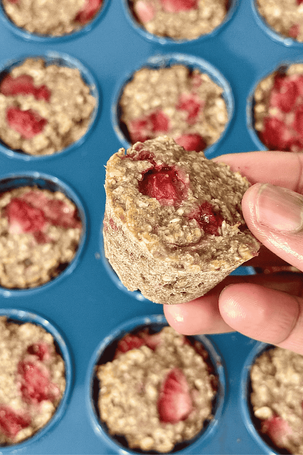 Freshly baked strawberry oatmeal cups made with oats and chopped strawberries, served on a light blue plate — a healthy and kid-friendly snack or breakfast option.
