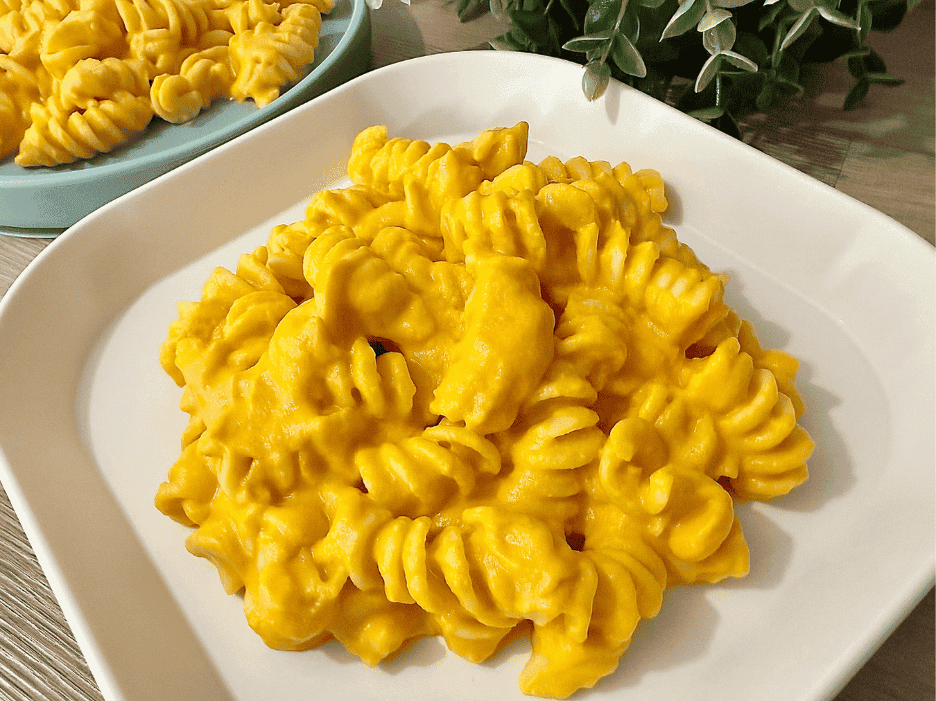 A bowl of creamy carrot pasta with a rich, smooth sauce, garnished with fresh herbs, perfect for a nutritious and kid-friendly meal.