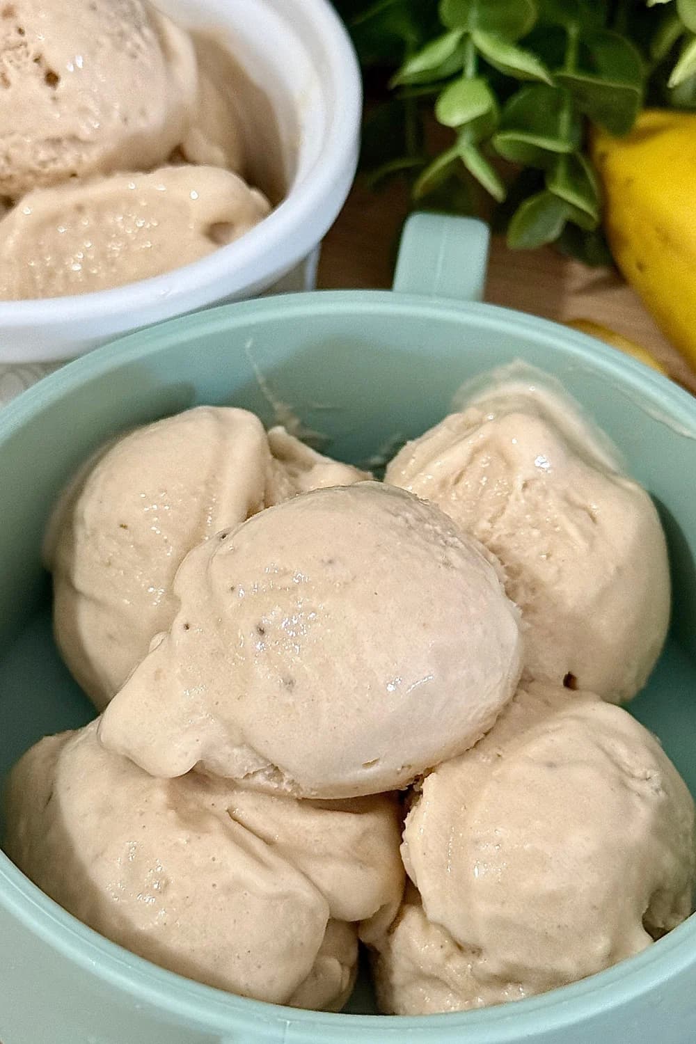 Healthy banana "nice cream" served in a teal ceramic bowl, perfect for a vegan dessert.