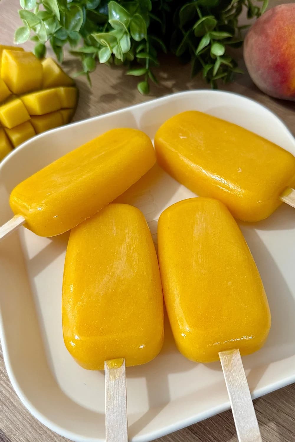 Homemade mango peach popsicles ready to be serve.