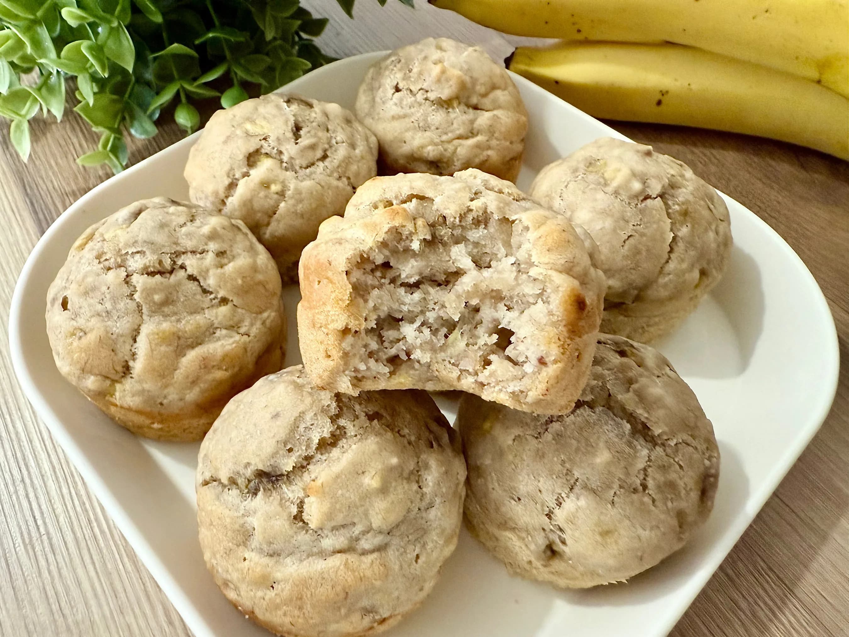 "Soft and fluffy eggless banana applesauce muffins arranged on a white plate, made with ripe bananas and applesauce, perfect for a healthy, dairy-free breakfast or snack."